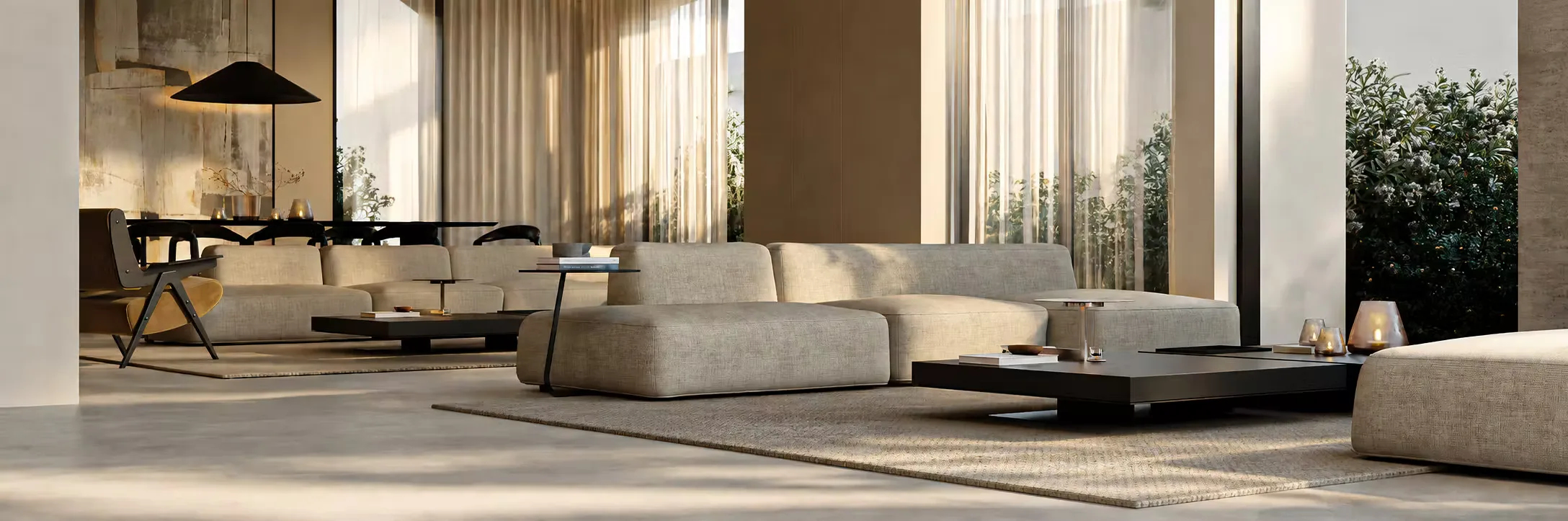 Wide view of a Konn home at dusk, its lit interiors glowing across the terrace and landscape.